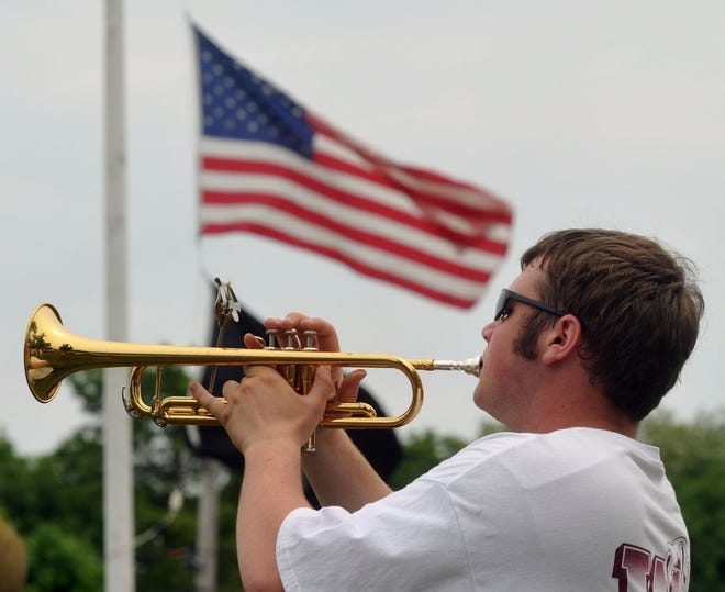 Weymouth High School marching band member T.J. Ritz plays Taps during the Weymouth Memorial Day parade.