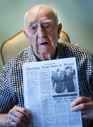 Walter Holmes of HIngham holds a newspaper article on his chance meeting with his brother Joseph in London in 1944, when the two were in the military.