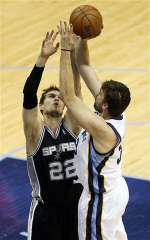Memphis Grizzlies center Marc Gasol (33) aims for the basket as San Antonio Spurs center Tiago Splitter (22) defends during the first half in Game 4 of the Western Conference finals NBA basketball playoff series, Monday, May 27, 2013, in Memphis, Tenn.
