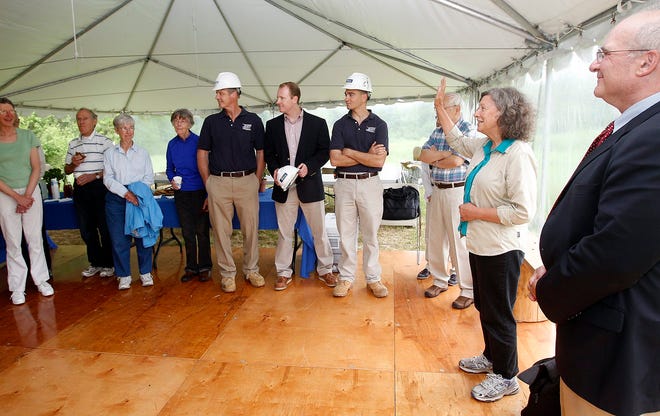 Sanctuary Director Elissa Landry ,2d right, waves as she recognizes certain people who helped with Thursday's ground breaking ceremony at the Broadmoor Wildlife Sanctuary in South Natick.