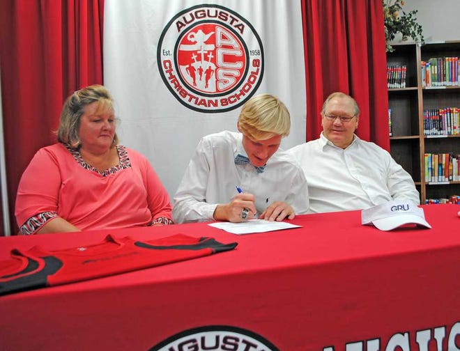 With parents Susan and Keith, Grant Newman signs his letter of intent to run track for Georgia Regents University.