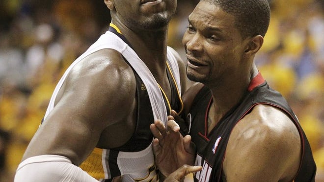 The Heat’s Chris Bosh (right) battles the Pacers’ Roy Hibbert during the fourth quarter of Indiana’s 99-92 win Tuesday night that evened the series at 2. Hibbert is averaging 22.8 points and 12 rebounds in the series, while Bosh’s averages are 14 and 3.3.