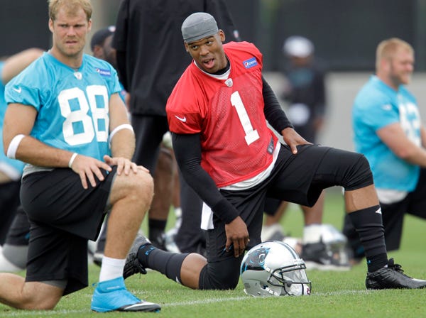 Carolina quarterback Cam Newton, right, and tight end Greg Olsen stretch before the Panthers’ team practice in Charlotte, N.C., on May 23. (Bob Leverone | Associated Press)