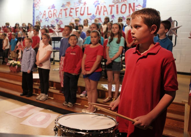 Andrew Kelly plays the drum for the VFW Color Guard presentation of the colors.

Chris Bernstein photo