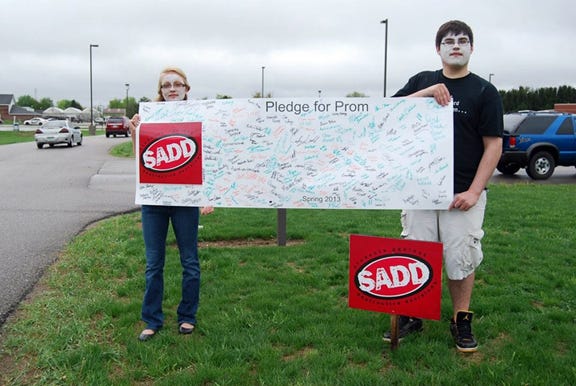 Shown are students in the Ionia High School's SADD group showing the signatures they received on their "Pledge for Prom" poster.