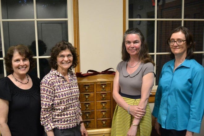 Sherborn Library staff help celebrate Elizabeth Johnston’s 25 years as library director on May 21. From left: Cheryl Ouellette, Donna Bryant, Elizabeth Johnston, Cindy Hinckley