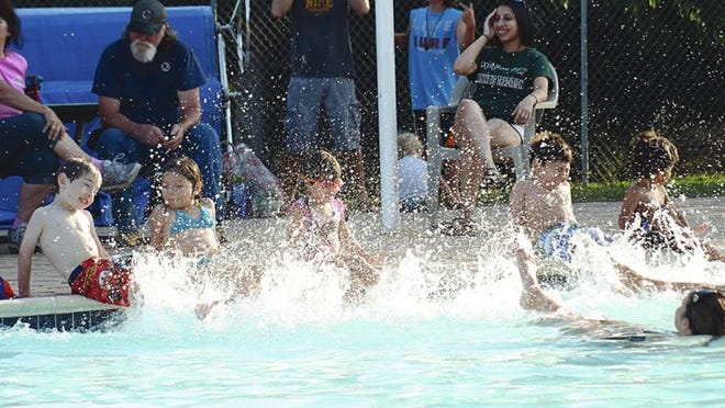 Children splash water at Gilleland Creek Pool. Part of being safe at a pool is knowing the pool. Teach children where the deep end is and set limits on where they can go before they go swimming.