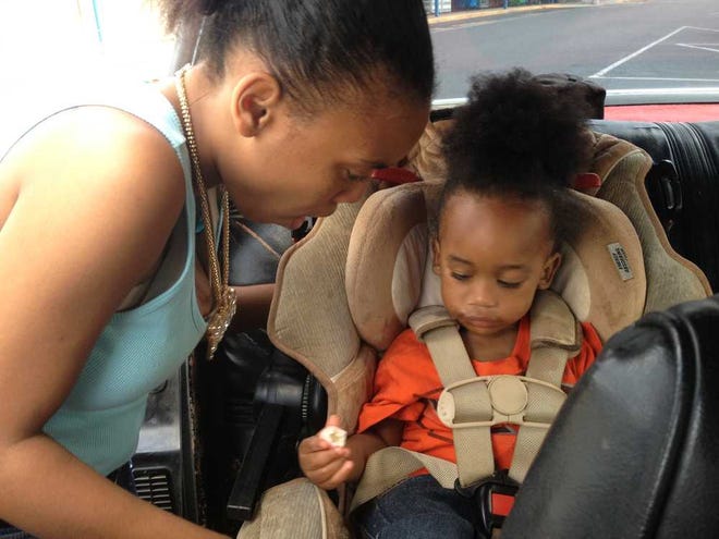 Ashley Burnett straps her 2-year-old son, Malachi, into a safety seat. On average, 38 children die in hot cars each year from heat-related deaths in the U.S.