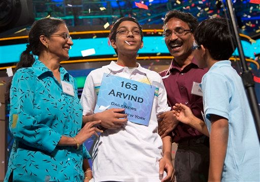 Arvind Mahankali, 13, of Bayside Hills, N.Y., is congratulated by his family as confetti falls after he won the National Spelling Bee by spelling the word "knaidel" correctly.