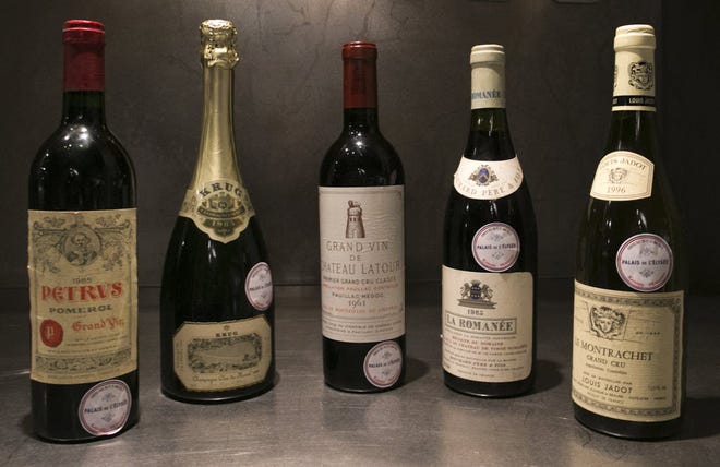 Bottles of fine wine put on auction by the French presidential Palace are displayed during an auction preview in Issy les Moulineaux, south of Paris, France. French President Francois Hollande’s palace has decided to dive into its wine cellar and sell some of its treasures, to raise money and replenish its collection with more modest vintages. About 1,200 bottles, a tenth of the Elysee’s wine collection, are to be sold at Drouot auction house in Paris on Thursday and today. Organizers say that prices may reach up to 2,200-2,500 euros for a 1990 Petrus down to 15 euros for a more modest wine.
