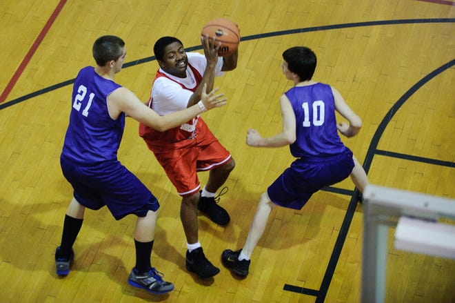 Jefferson City’s Clarence Bentley, center, shoots between a pair of St. Joe’s players during the Special Olympics Missouri State Summer Games. Bentley scored 28 points in a 43-33 victory.