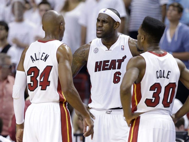 Miami Heat forward LeBron James (6), center, talks to Miami Heat guard Ray Allen (34) while Miami Heat guard Norris Cole (30) listens during the second half of Game 5 in their NBA basketball Eastern Conference finals playoff series, Thursday, May 30, 2013 in Miami.
LYNNE SLADKY | AP PHOTO