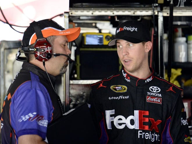 Denny Hamlin, right, talks in the garage area during practice on Friday at Dover International Speedway.
NICK WASS | THE ASSOCIATED PRESS