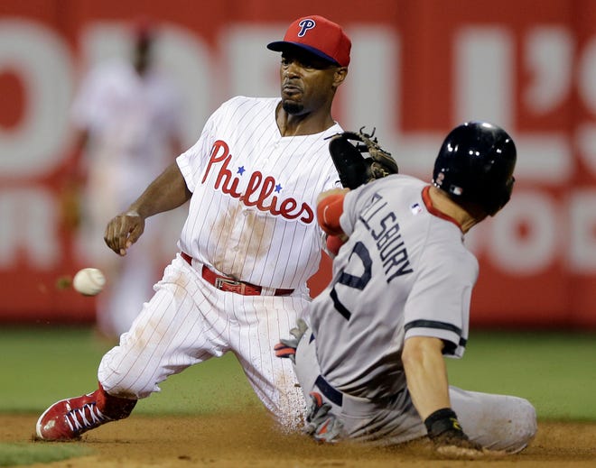 Jacoby Ellsbury (right) steals second base as Philadelphia shortstop Jimmy Rollins tries to handle the throw from home in the eighth inning of an interleague baseball game on Thursday. It was Ellsbury's team-record fifth steal of the game.