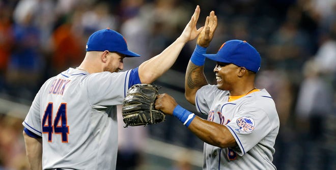 New York Mets right fielder Marlon Byrd, right, celebrates with catcher John Buck (44) after the the Mets defeated the New York Yankees 3-1 to complete a four game sweep after an interleague baseball game series at Yankee Stadium in New York, Thursday, May 30, 2013.