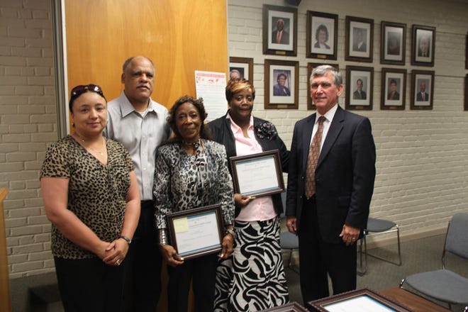 Shown at the Iberville Parish School Board are school leadership administrators Gail Edwards, who will lead the White Castle College Readiness Program, WHS Principal Charles Handy, and Superintendent Dr. C. Edward Cancienne, Jr. presenting plaques honoring the late Alberta Hasten to her sisters, Earthley Baptiste and Evangeline Davis.