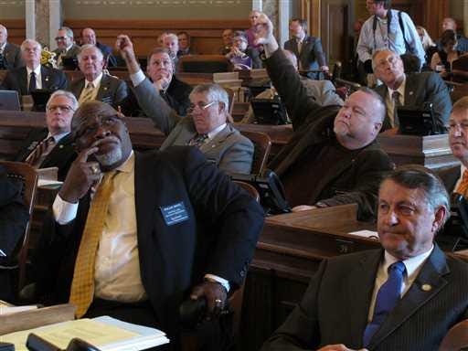 Kansas House members John Bradford, left, of Lansing, and Joe Edwards, right, of Haysville, indicate their desire to change their vote on a tax bill considered earlier this week. The House has turned down every tax proposal and compromise sent its way by the Kansas Senate during the impasse that has extended the current session of the Legislature.
