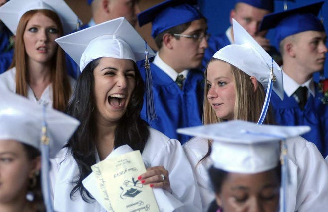 West Boylston High graduate Jillian Lombardi enjoys a laugh with fellow grad, Noura Chyoghly, right, during graduation exercises at the school this evening.