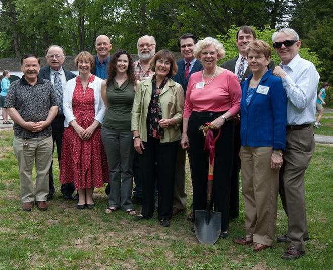 Members of First Parish's construction committee and project team at the ceremonial groundbreaking included, front row, from left, Oscar Vasquez, Susan Keyes, Lisa Maria Steinberg, Lynne Spencer (architect), Barbara Buell (with the shovel), and Lynn Trimby; back row, The Rev. John Nichols, Patrick Guthrie (architect), John Thompson, Ted Pyne (contractor), Bill Morrison and Ross Trimby
