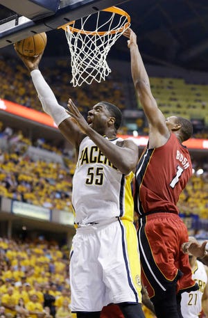 Indiana Pacers center Roy Hibbert goes up for a shot against Miami center Chris Bosh. Hibbert had 24 points and 11 rebound as Indiana evened the series.