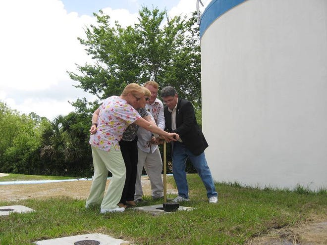 Opening the valve to Bunnell’s new aeration tank Wednesday are, from left, City Commissioner Jenny Crain-Brady, Mayor Catherine Robinson, Vice Mayor John Rogers and County Commission Chairman Nate McLaughlin. The tank is part of an upgrade to the city’s water utility.