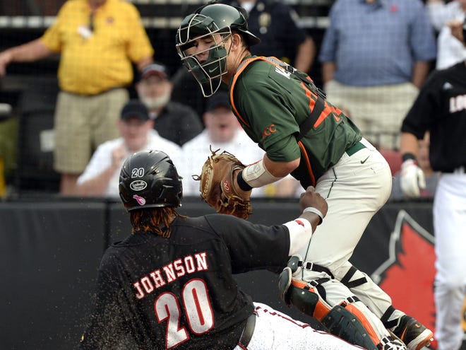 Louisville's Coco Johnson, bottom, is forced out at home by Miami catcher Garrett Kennedy during the seventh inning of Saturday's regional game in Louisville, Ky. Louisville defeated Miami 6-4.