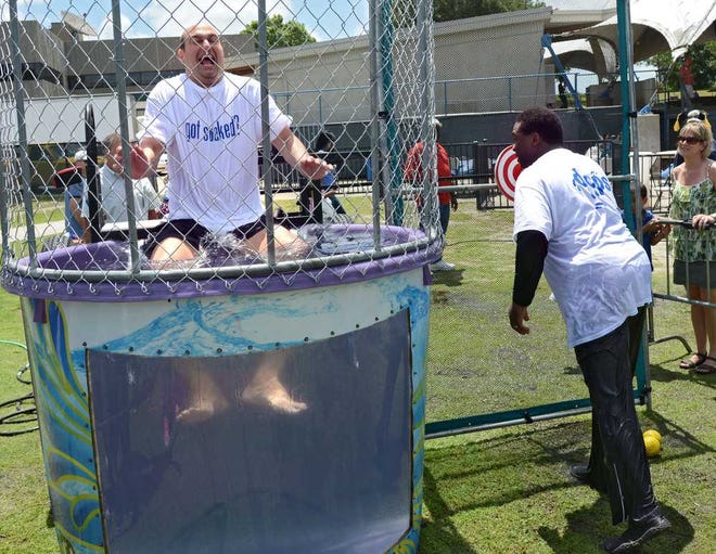 Photos by Bob.Mack@jacksonville.com Duval County Schools Superintendent Nikolai Vitti was dunked in the "Shark Tank" by Mayor Alvin Brown in payback after Vitti threw a ball to dunk the mayor during the Public Education Partners (PEP) rally in Metropolitan Park on Saturday.