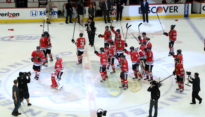 The Chicago Blackhawks celebrate after their win over the Detroit Red Wings 2-1 in overtime in Game 7 of the NHL hockey Stanley Cup Western Conference semifinals, Wednesday, May 29, 2013, in Chicago. (AP Photo/Daily Herald, Steve Lundy) MANDATORY CREDIT; MAGS OUT; TV OUT