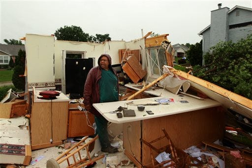 Wilburn Shaw looks for personal items in the remains of his kitchen in his home on Saturday after Friday night's storm that passed through the St. Charles, Mo., area. (AP Photo/St. Louis Post-Dispatch, Huy Mach)