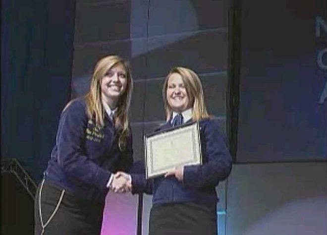 Pictured: State FFA Vice President, Sierra Milligan, presents Winder-Barrow FFA President, Bryanna Cash, with a GOLD Emblem National Chapter Award at the Georgia FFA State Convention held in Macon in April. The State FFA Associations recognize the top 10 percent of chapters as Gold Emblem chapters. The Winder-Barrow FFA will compete in the National FFA Convention in October.