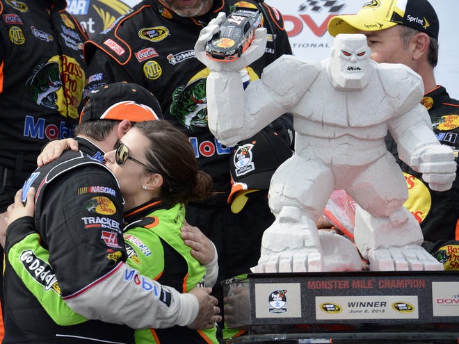Tony Stewart, left, gets a hug from fellow driver Danica Patrick, right, in Victory Lane after Stewart won the FedEx 400 on Sunday at Dover International Speedway in Dover, Del. (AP Photo/Nick Wass)
