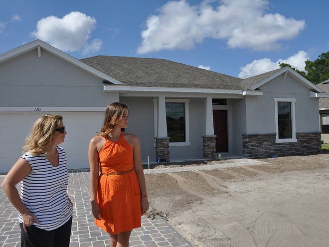 Stephanie and Chelsea Peel look over the yard of their new Gallery 1,800-square-foot home in DeLand on Tuesday afternoon.