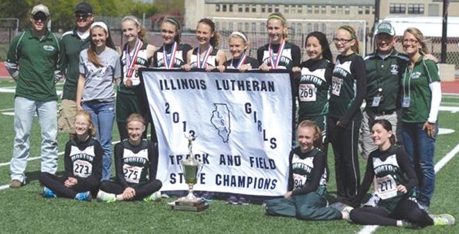 The Bethel Lutheran School girls track and field team won the Lutheran Sports Association state championship May 12 in Chicago. It was the first state title for Bethel in school history in any sport. At the same meet, the Flames placed ninth on the boys side. Members of the squad are, in front, from left: Hannah Johnson, Amanda Lichtenstein, Chloe Siscoe and Jenna McCartney; second row: coach Dalton White, coach Todd Krueger, Ashley Mohr, Meredith McDonough, Lexie Collins, Mollie Krueger, Macy Glatz, Brandi Bisping, Katie Adams, Kaylee Lichtenstein, coach Greg Nichols and coach Sara Glatz.