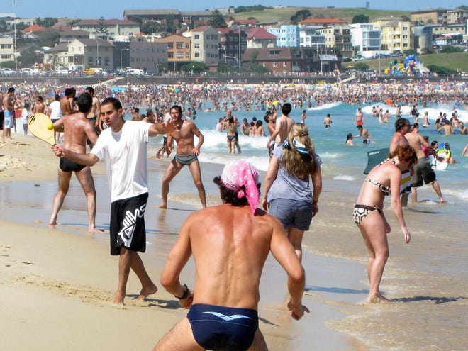 FILE - In this Jan. 6, 2009 file photo, people play on the shoreline of Bondi Beach in Sydney. If worry about skin cancer doesn't make you slop on sunscreen, maybe vanity will: New research provides some of the strongest evidence to date that near-daily sunscreen use can slow the aging of your skin. The new study, from Australia's Sunshine Coast, used a unique step to measure whether sunscreens really help that constant onslaught. Researchers compared fine lines on the hands of hundreds of people who, for more than four years, had been assigned to rub on sunscreen daily or only when they deemed it necessary. (AP Photo/Rob Griffith, File)