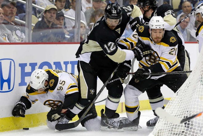 Pittsburgh's Jarome Iginla is caught between Boston's Johnny Boychuk (left) and Andrew Ference. The Bruins claimed a 2-0 lead in the Eastern Conference Finals.