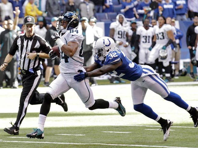 Jacksonville Jaguars wide receiver Cecil Shorts, No. 84, breaks the tackle of Indianapolis Colts defensive back Cassius Vaughn on his way to an 80-yard touchdown in the final minute of an NFL football game in Indianapolis in 2012. The Jaguars defeated the Colts 22-17.