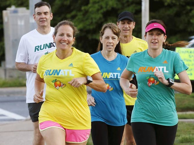 Shawna Block, left (in yellow), recently runs along Johnson Ferry Road in Marietta, Ga., with a group including, from left: Spurgeon Hendrick, Laura Rhea, Adam Feder and Cathy Smith. They stress the importance of wearing bright colors for visibility.