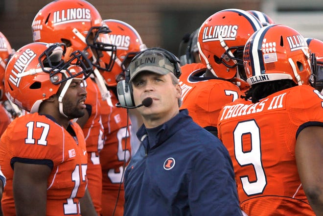 In this Nov. 10, 2012 photo, Illinois head coach Tim Beckman looks at the clock during a time out during the first half of an NCAA college football game between Illinois and Minnesota in Champaign, Ill. The Illini are the only Big Ten team without a conference win this season. Purdue plays at Illinois this Saturday, Nov. 17.(AP Photo/Seth Perlman)