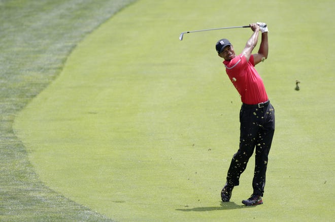 Tiger Woods hits a shot on the 11th hole during the final round of the Memorial golf tournament on Sunday, June 2, 2013, in Dublin, Ohio. (AP Photo/Jay LaPrete)