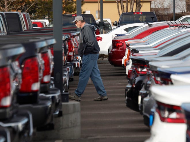 In this Jan. 20, 2013, photo, a buyer moves between rows of 2013 Ram pickup trucks and Dart sedans at a Dodge dealership in Littleton, Colo. Chrysler's U.S. sales rose 11 percent in May, a sign that auto sales rebounded from a slight dip in April and will continue to boost the U.S. economy. Ram pickup truck sales were strong, up 22 percent over a year ago to almost 32,000.