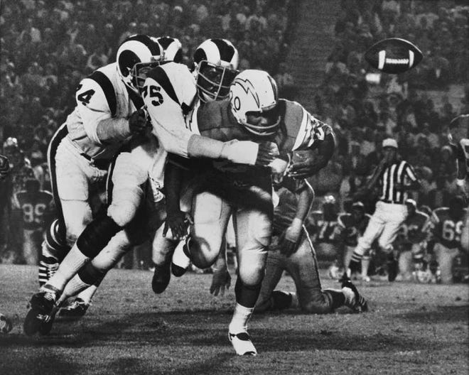 The Los Angeles Rams' Deacon Jones knocked the ball from San Diego back Mike Garrett in this 1971 game. The Hall of Famer was credited with coining the term sack. knocked down quarterbacks, was 74. The Washington Redskins said that Jones died of natural causes at his home in Southern California on Monday night, June 3, 2013. (AP Photo)