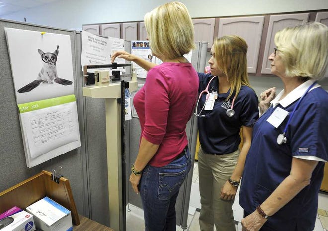 Photos by Bob.Self@jacksonville.com Green Cove Springs resident Dawn DeLisle is screened by UNF nursing student Ivana Svetlik while nurse Norma Chao watches.