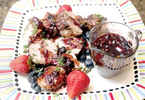 Photo by Daniel Freel/New Jersey Herald - Amy Casey’s grilled pork tenderloin with a berry bacon sauce is one of her favorite summer dishes to prepare as fresh fruit is beginning to become available at local farmers’ markets.