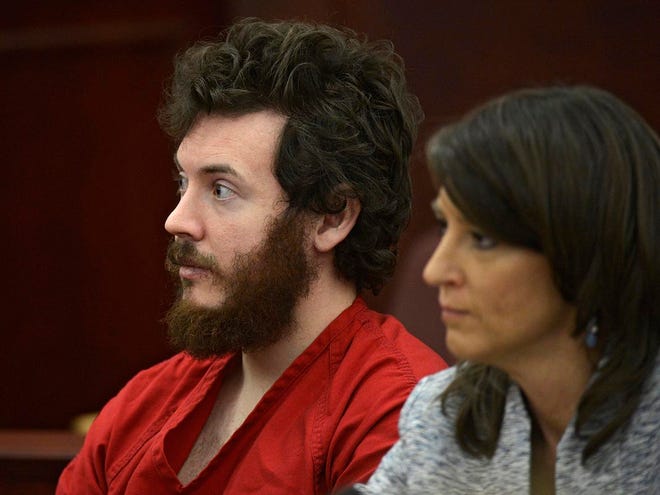In this March 12 photo, James Holmes, left, and defense attorney Tamara Brady appear in district court in Centennial, Colo. for his arraignment. A judge on Tuesday accepted Holmes’ plea of not guilty by reason of insanity, setting the stage for a lengthy mental evaluation of the Colorado theater shooting suspect.