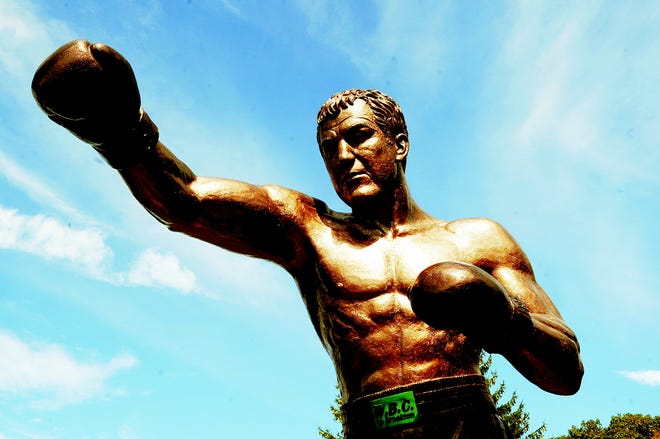 The statue dedicated to undefeated champion Rocky Marciano was completed Thursday, Sept. 20, 2012, as work crews hoisted and then connected the top section of the 22-foot artwork.