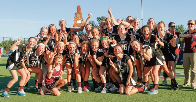 The Portsmouth girls lacrosse team celebrates winning the Division II state title over Hanover Tuesday at SNHU.