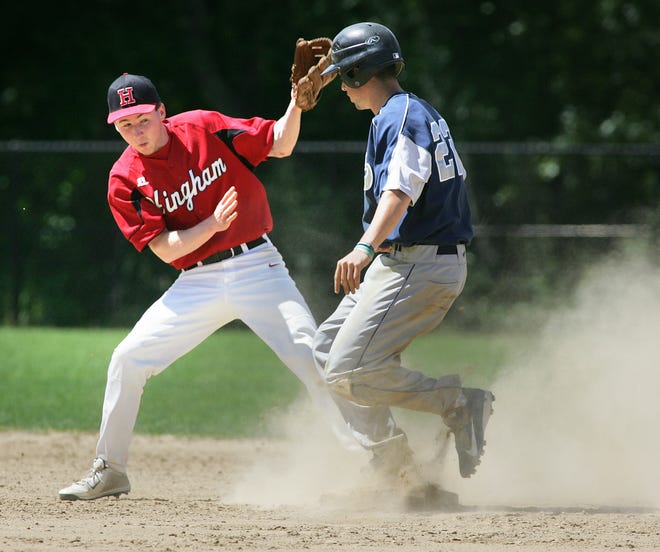 Plymouth North Brendan Beane is safe as Hingham baseman Cody Clifford bobbles the ball on Tuesday, June 4, 2013.