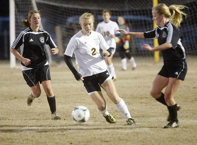 Havelock's Natalie Johnson splits a pair of New Bern defenders in a match earlier this year. Johnson was named to the N.C. Soccer Coaches Association all-state team.