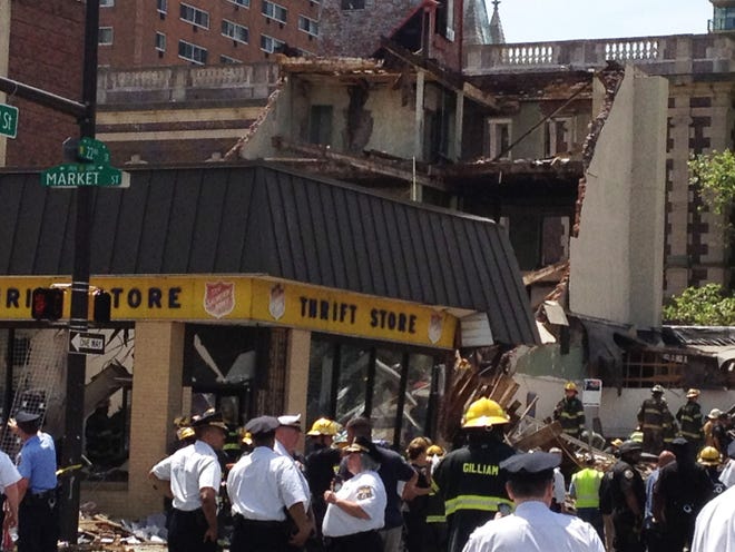 Emergency personnel respond to a building collapse in downtown Philadelphia, where the city fire commissioner says as many as eight to 10 people are believed trapped in the rubble, on Wednesday.