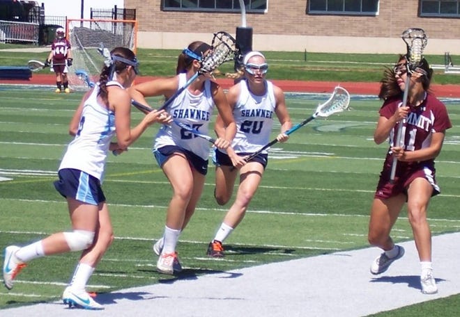 Shawnee lacrosse players (from left) Caroline Farley, Carly Damato and Jill Chiachetti converge on Summit's Anna Johnson as she brings the ball upfield during first half action in Wednesday's Tournament of Champions game. Shawnee defeated the Hilltoppers, 13-12, in overtime, to advance to Saturday's final.